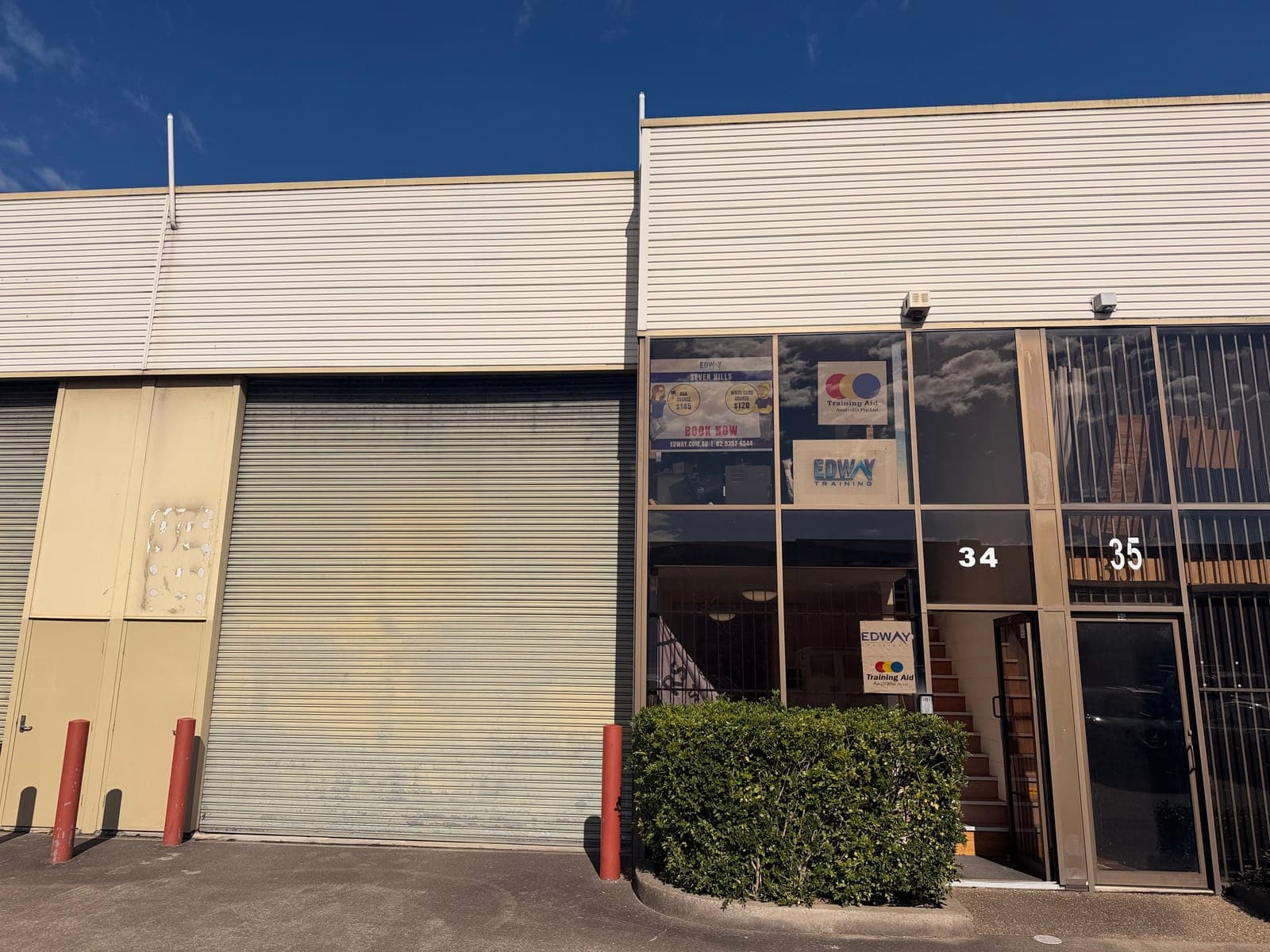Edway Training and Training Aid's Seven Hills centre: the glass entrance to Unit 34 beside a roller door, in a row of industrial units.